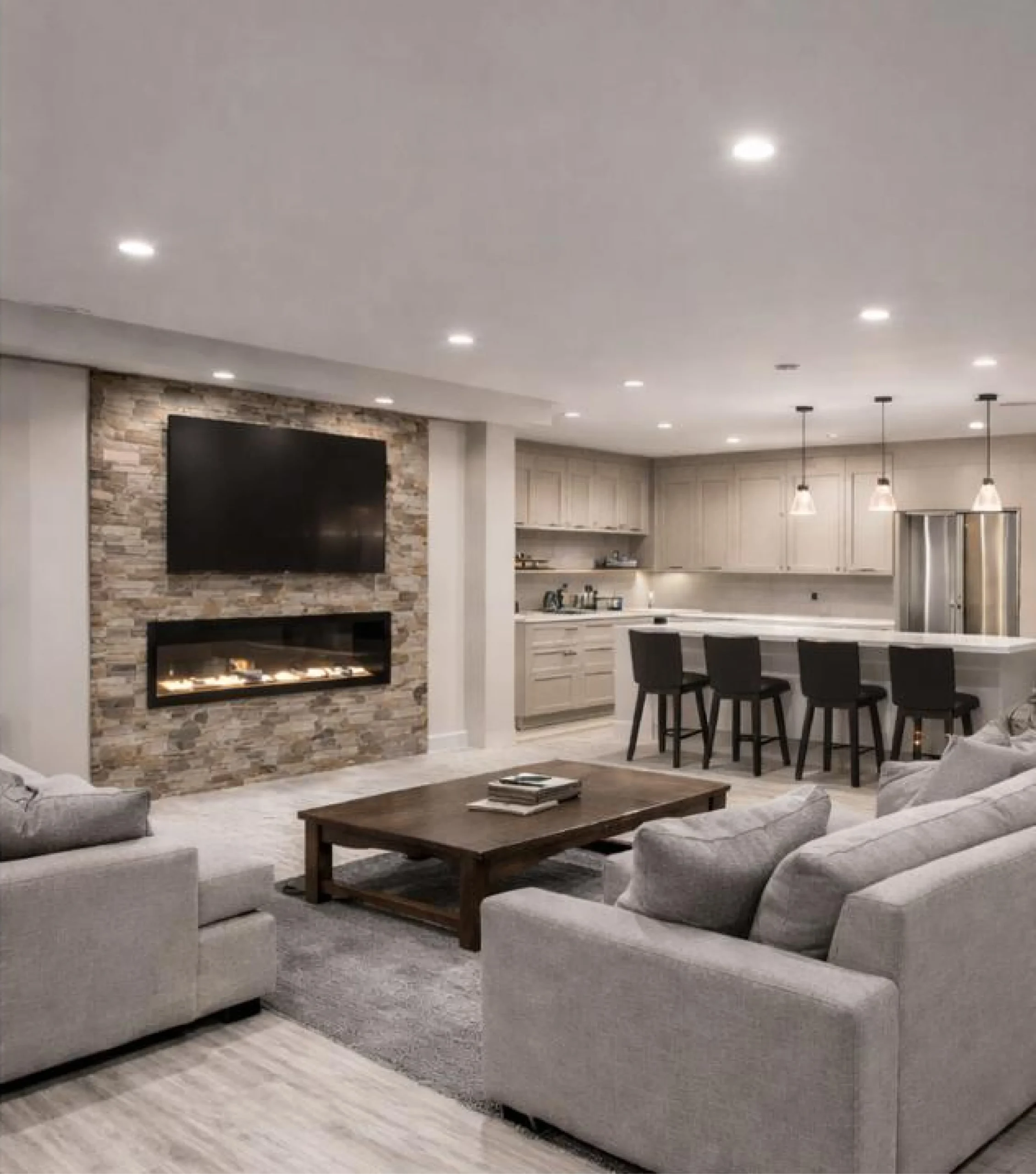 After renovation: updated living room and kitchen with a modern design, high-quality finishes, and cohesive styling by MGM Home Solutions in Connecticut.